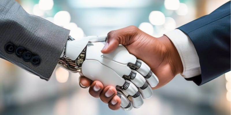 A handshake between a human hand and a robotic hand.