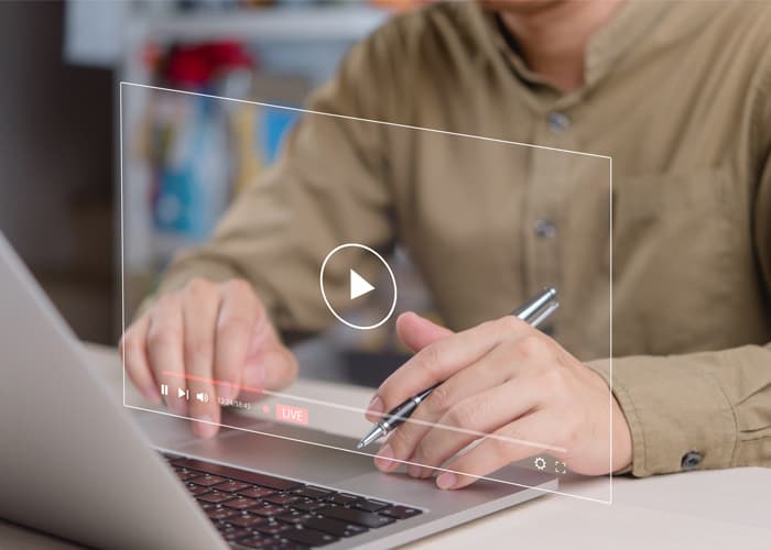 Businessman watching and interacting with live streaming video on laptop