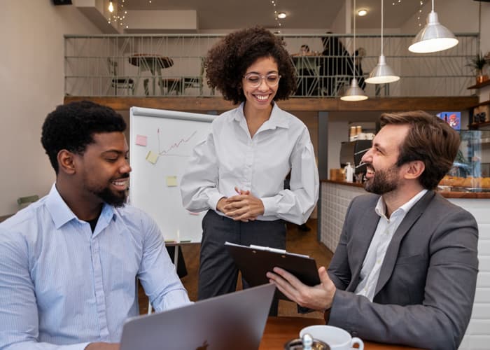 Three coworkers enjoying working together on a project.