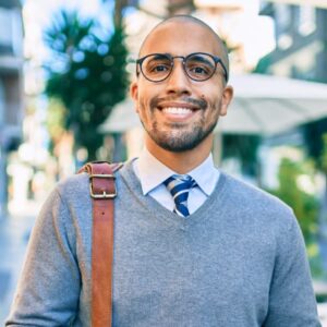 Smiling government IT employee leaving office after successfully completing a productive workday.