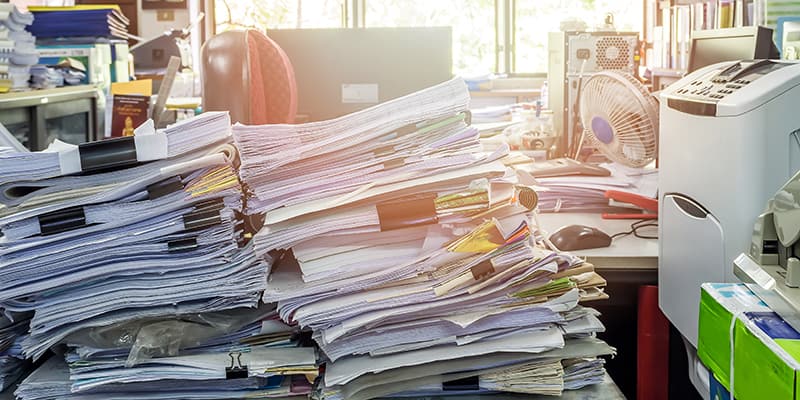 Stacks of papers on a desk in a government clerk's office